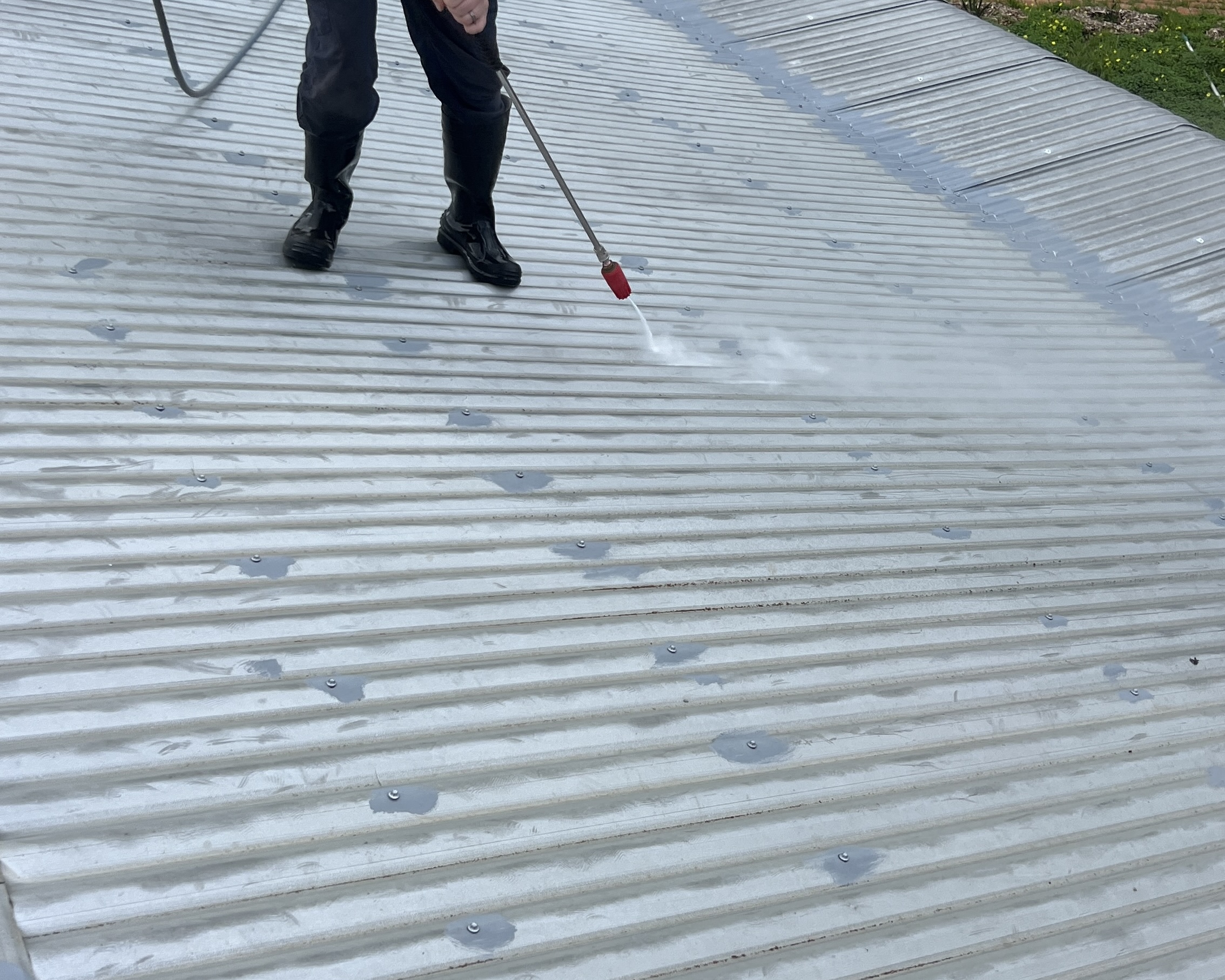 Professional metal roof cleaning using controlled pressure washing to remove dirt, grime and organic build-up in Perth.