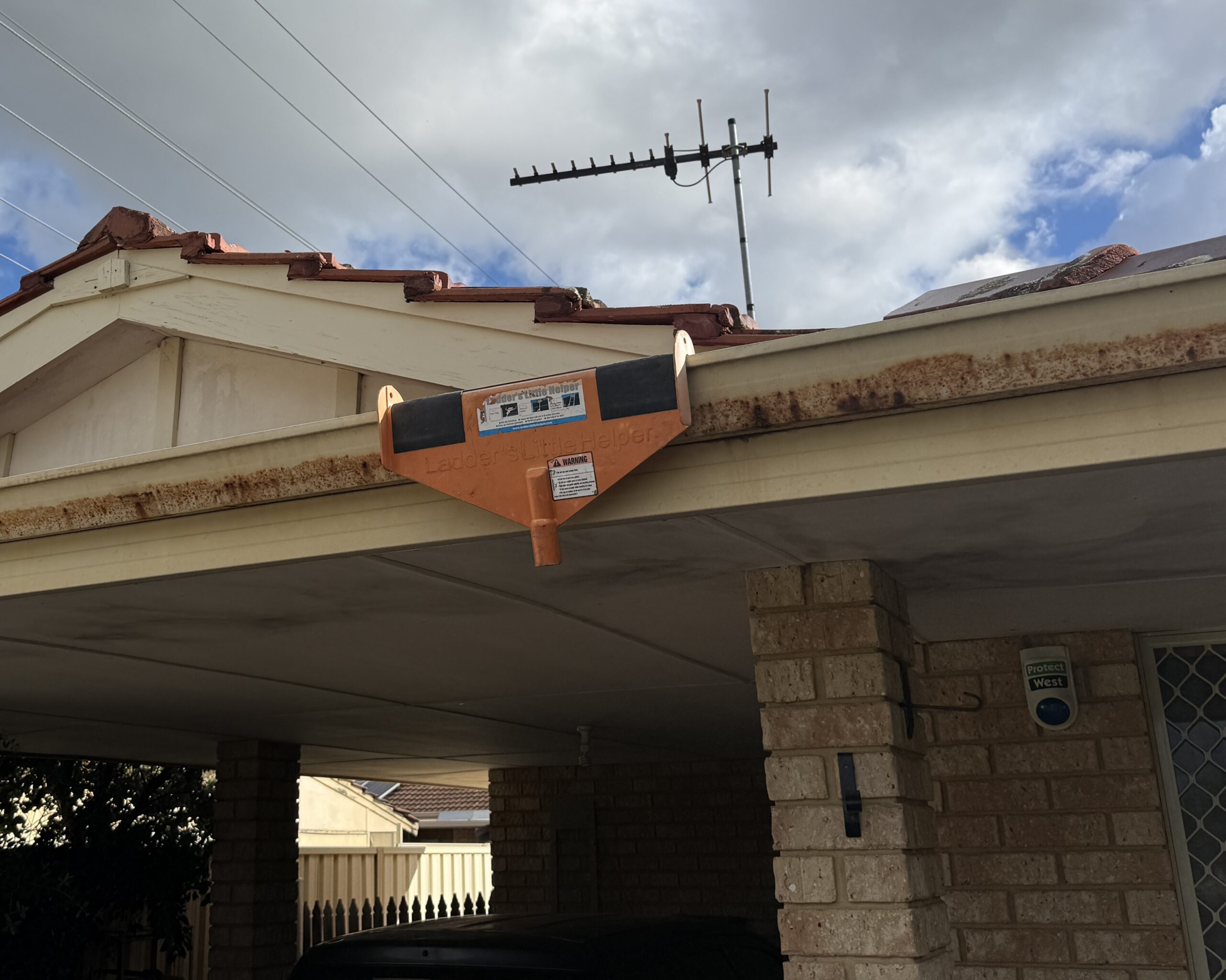 Steel gutter showing corrosion caused by acidic runoff from lichen growing on the roof.