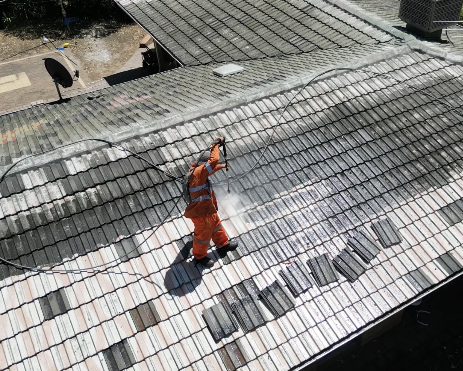 Professional tile roof cleaning preparing a concrete tile roof for restoration in Perth.